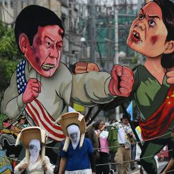 Se ven efigies del presidente filipino Ferdinand Marcos y la vicepresidenta Sara Duterte mientras los manifestantes marchan hacia el Congreso durante una manifestación que coincide con el discurso sobre el estado de la nación de Marcos, en Manila. | Foto:TED ALJIBE / AFP