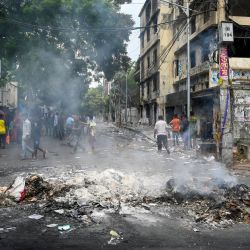 El humo se eleva cerca de la oficina del partido Liga Awami quemada cuando los manifestantes antigubernamentales incendiaron la oficina en Dacca, después de que la ex primera ministra Sheikh Hasina huyera del país. Los líderes estudiantiles de Bangladesh exigieron el 6 de agosto que el ganador del Nobel Muhammad Yunus liderara un gobierno interino, un día después de que los militares tomaran el control cuando las manifestaciones masivas obligaron a la gobernante Sheikh Hasina a huir del país. | Foto:MUNIR UZ ZAMAN / AFP
