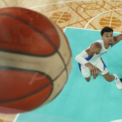 Victor Wembanyama, de Francia y Dillon Brooks de Canadá, miran la pelota en el partido de cuartos de final de basquet masculino entre Francia y Canadá durante los Juegos Olímpicos de París 2024 en el Bercy Arena en París. | Foto:JAMIE SQUIRE / POOL / AFP