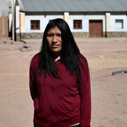 Anahí Jorge, 23, an emloyee at a lithium mining company, poses for a picture after an interview with AFP in Susques, Jujuy Province, Argentina on July 2, 2024. 