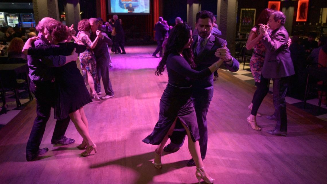 Professional ‘Tango Taxi dancers’ David Tolosa and Laura Florencia Guardia dance during a milonga at the Marabu tango saloon in Buenos Aires on August 17, 2024.  