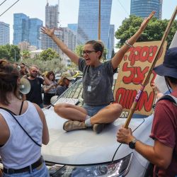 Un manifestante hace un gesto mientras las familias y los partidarios de los rehenes israelíes retenidos por militantes palestinos en la Franja de Gaza desde octubre celebran una manifestación para pedir su liberación en Tel Aviv, en medio del conflicto en curso en la Franja de Gaza entre Israel y el movimiento militante palestino Hamás. | Foto:JACK GUEZ / AFP