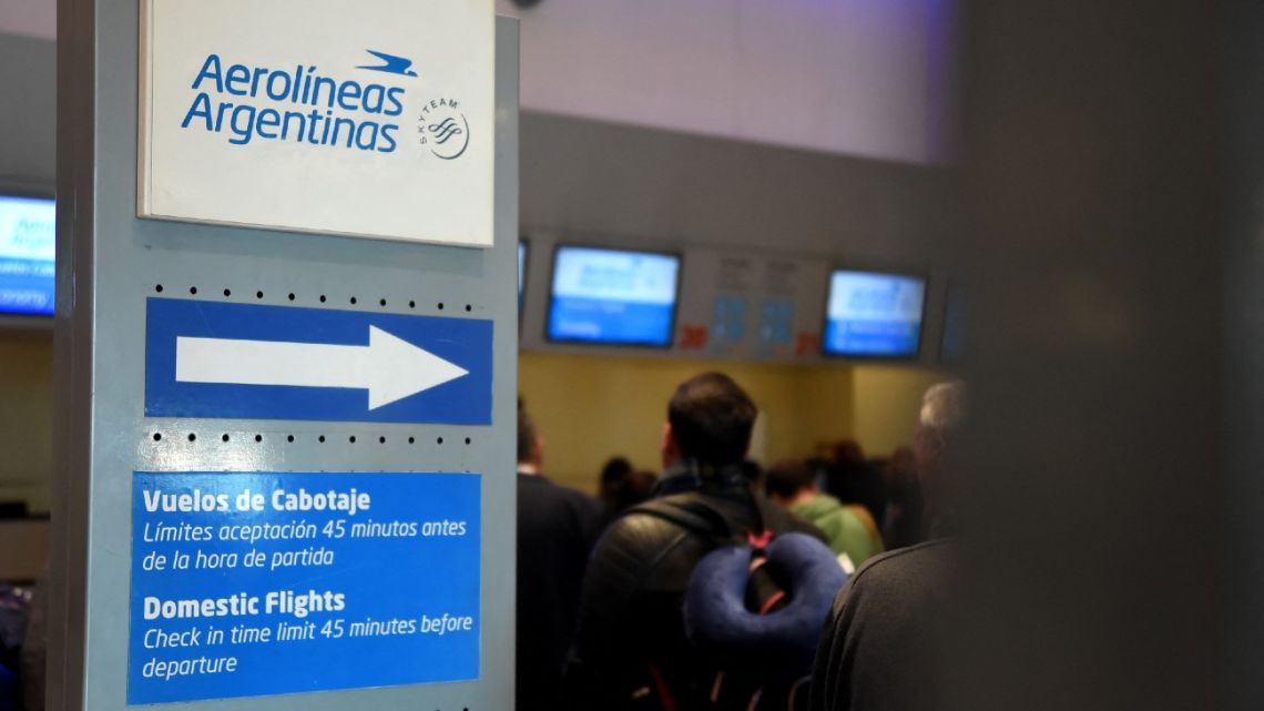 An Aerolíneas Argentinas sign is pictured next to counters at an airport in Mendoza on August 27, 2024.