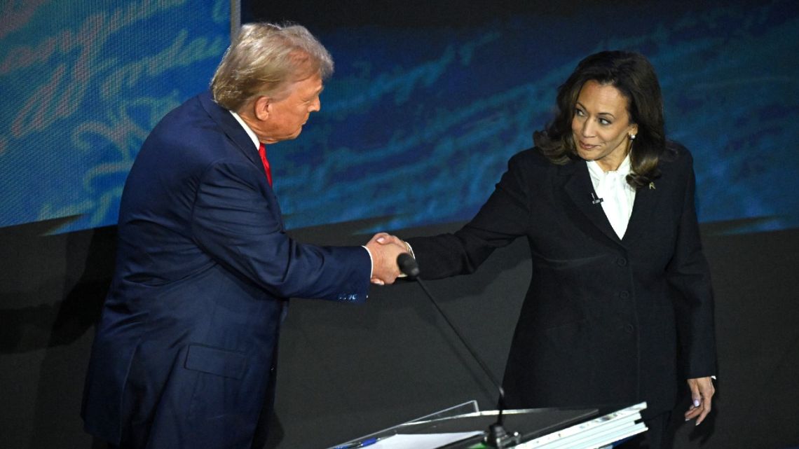 US Vice-President and Democratic presidential candidate Kamala Harris (R) shakes hands with former US President and Republican presidential candidate Donald Trump during a presidential debate at the National Constitution Center in Philadelphia, Pennsylvania, on September 10, 2024.  