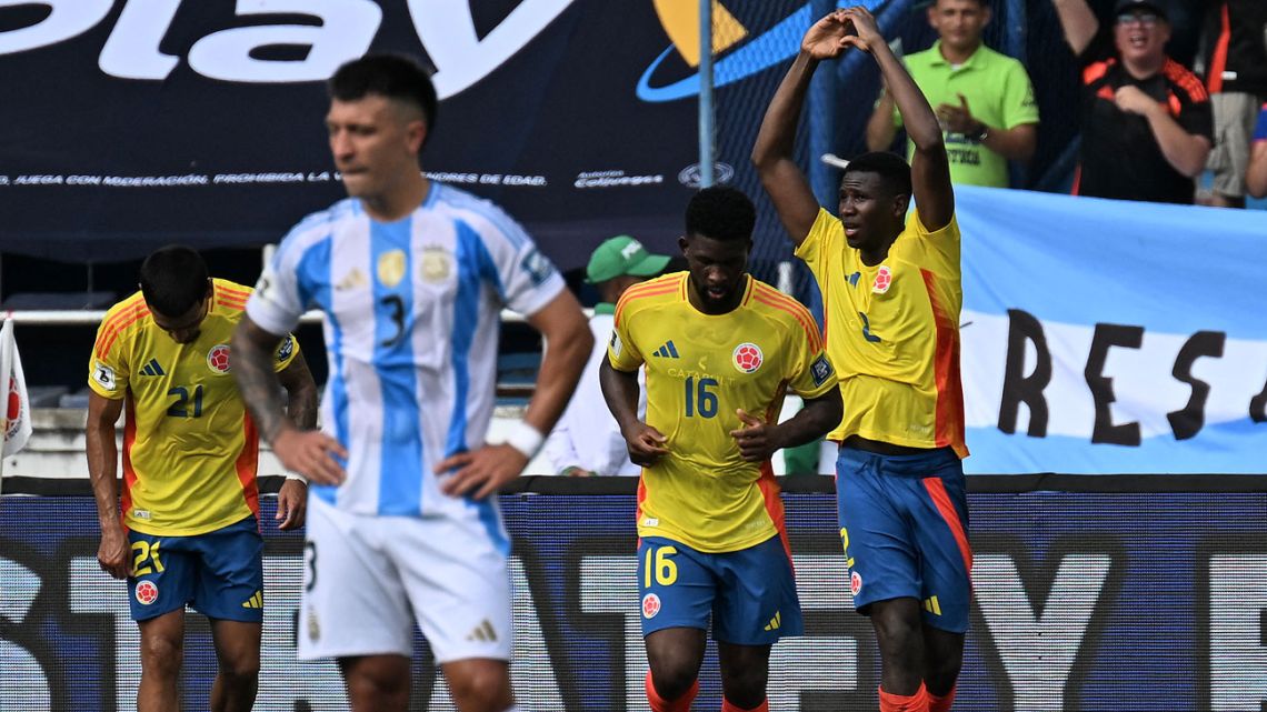 Colombia's defender Yerson Mosquera (right) celebrates scoring his team's first goal during the 2026 FIFA World Cup South American qualifiers football match between Colombia and Argentina, at the Metropolitano Roberto Meléndez stadium in Barranquilla, Colombia, on September 10, 2024. 