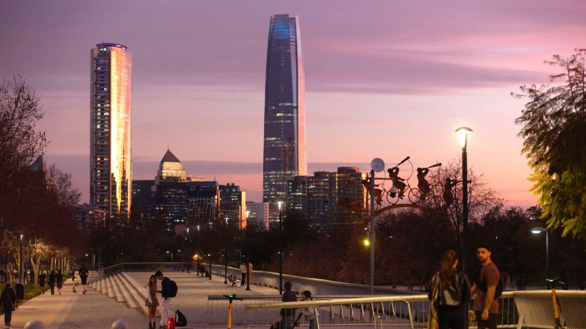 Couples walk along the esplanade of the Bicentennial Park in the commune of Vitacura in Santiago on September 5, 2024.