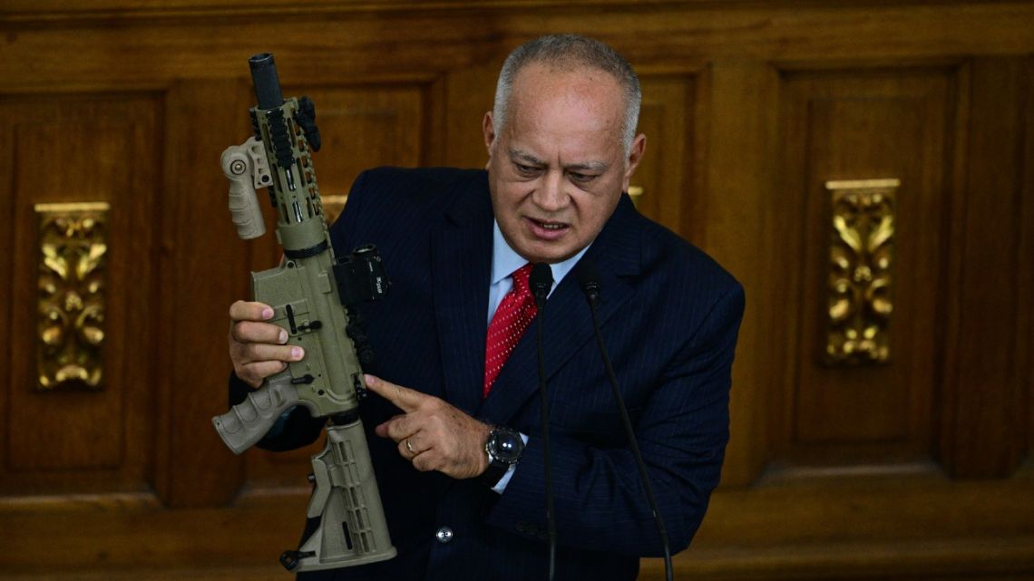 Venezuela's Interior Minister Diosdado Cabello holds a US made M4A1 rifle as he speaks during a session at the National Assembly in Caracas on September 17, 2024. 