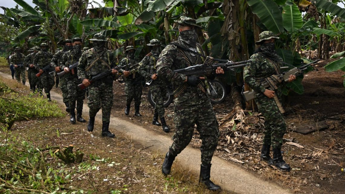 Members of the FARC dissident group Segunda Marquetalia march on a farm in Llorente, a rural area of the port city of Tumaco, Nariño department, Colombia, on August 31, 2024. 