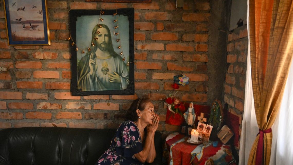 Otilia Ante, mother of retired Colombian military officer Alexander Ante, prays next to a makeshift altar at her home in Popayan, Cauca department, Colombia, on September 12, 2024. 