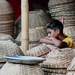 Un niño descansa sobre cestas de bambú mientras espera a los clientes en su tienda en Dhaka. Foto de Munir Uz Zaman / AFP | Foto:AFP