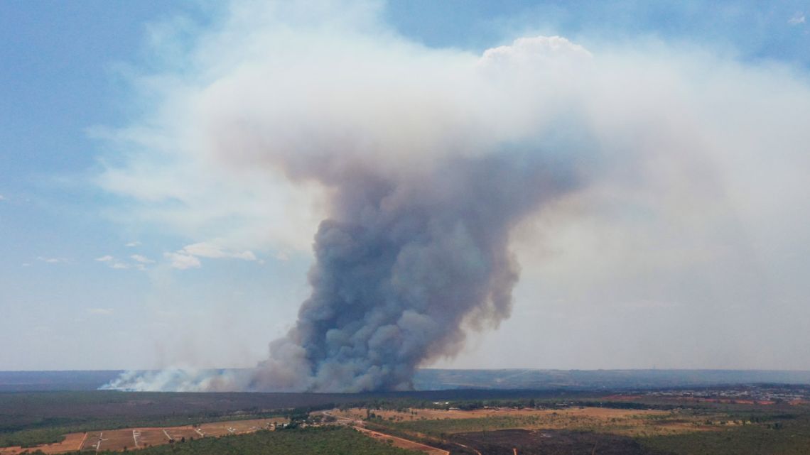 This aerial view shows smoke billowing from a forest fire affecting the Brasília National Park in Brasília on September 16, 2024. Brazil is suffering the effects of a multiplication of fires from north to south in the midst of an extreme drought linked to climate change. Smoke clouds cover a large part of the territory of Latin America's largest country—"up to 80%” last week—according to Karla Longo, a researcher at the National Institute for Space Research (INPE).  