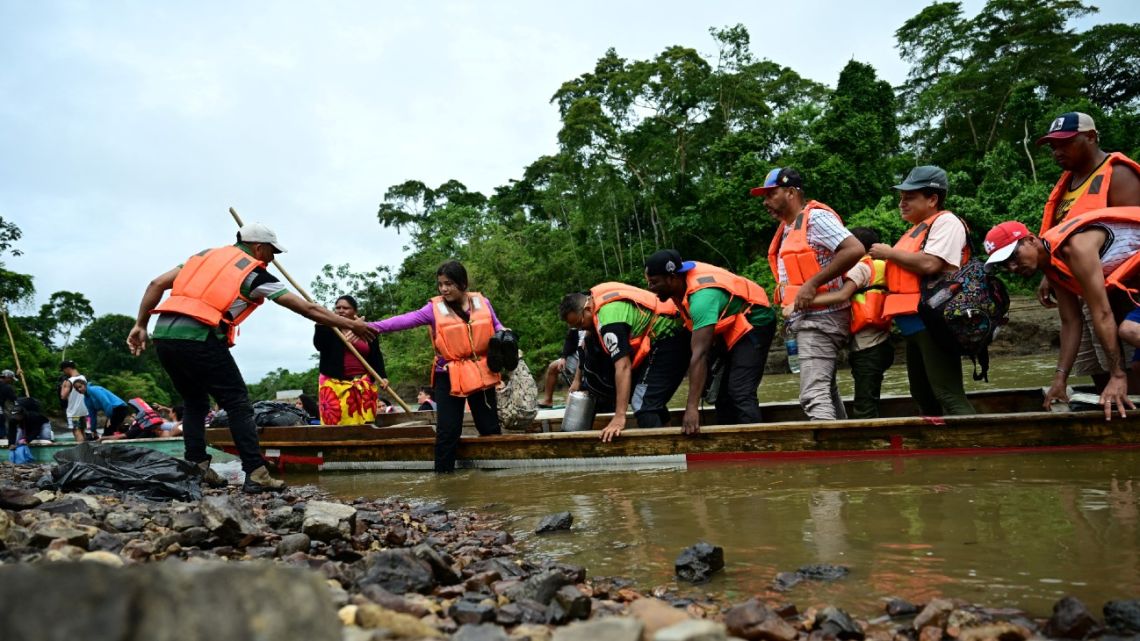 Migrants get ready to get off the boat on arrival at the Temporary Reception Centre for Migrants in Lajas Blancas, in the jungle province of Darien, 250 km east of Panama City, Panama, on September 26, 2024. 