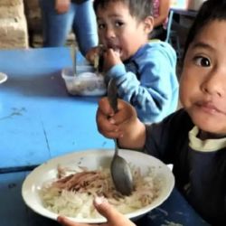 A child eats at a soup kitchen.