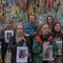 Los asistentes sostienen carteles con retratos y cantan el himno nacional de Ucrania, en el "Día de los Defensores" en Kiev. Foto de Roman PILIPEY / AFP | Foto:AFP