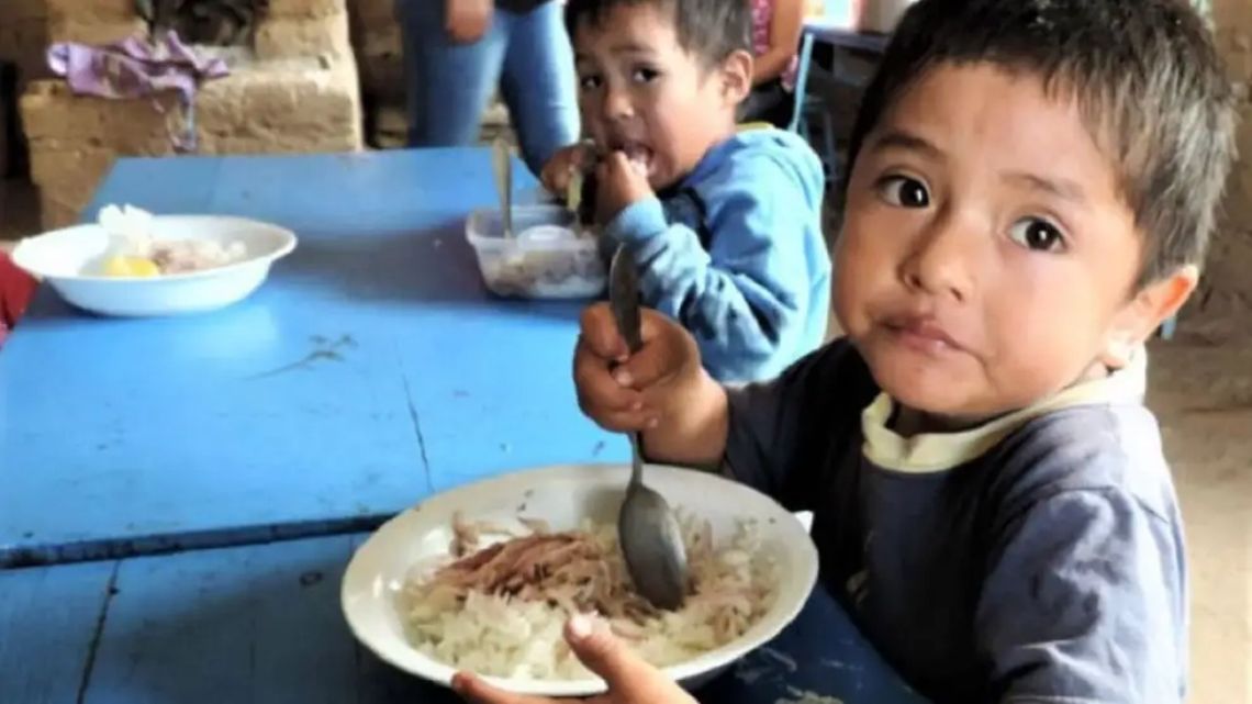 A child eats at a soup kitchen.