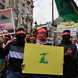Banderas de Hamás y el logotipo de la milicia chií libanesa Hezbolá durante una manifestación en Cisjordania para conmemorar el aniversario del ataque del grupo militante palestino Hamás. Foto de Zain JAAFAR / AFP | Foto:AFP