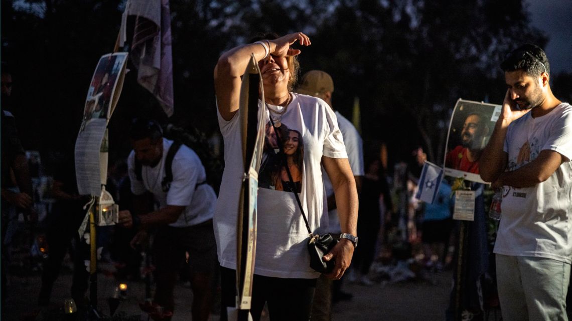 A woman cries as relatives and supporters of Israelis killed in the October 7 Hamas attack attend a ceremony at the Nova memorial near Kibbutz Reim in southern Israel on the first anniversary of the attacks, October 7, 2024. 