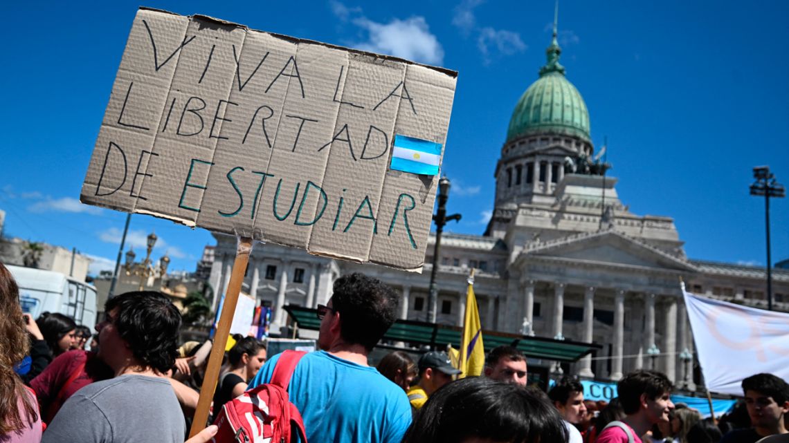 A university student protests holding a sign reading 'Long live the freedom to study' outside the Congress while lawmakers debate President Javier Milei's veto of a law that seeks to improve the budget of higher education institutions in Buenos Aires on October 9, 2024.