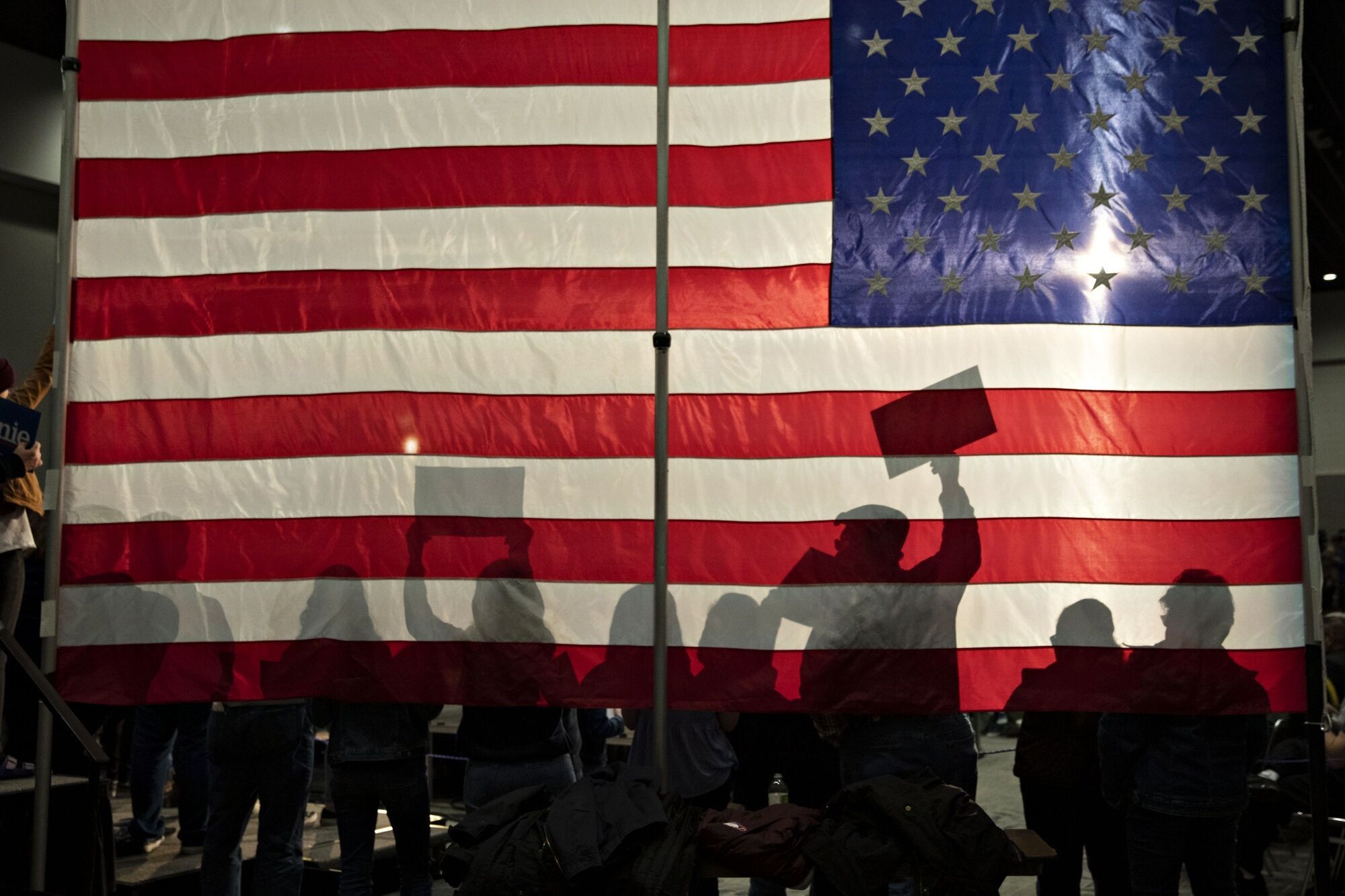People Silhouetted Against An American Flag