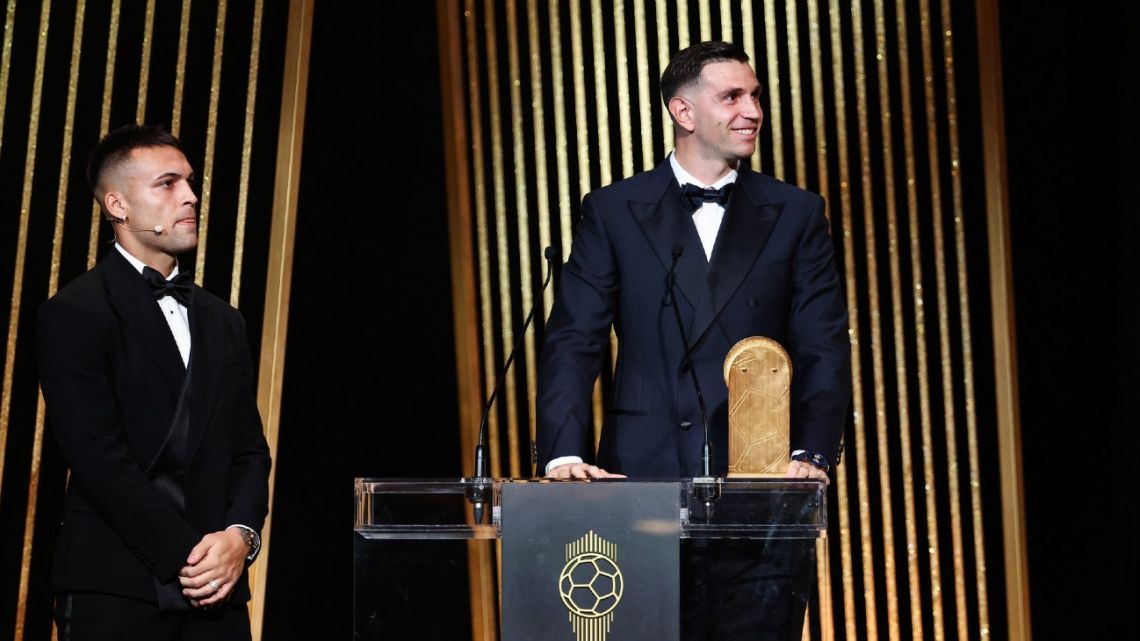 Emiliano Martínez receives the Yashin Trophy for best goalkeeper from Lautaro Martínez during the 2024 Ballon d'Or France Football award ceremony at the Theatre du Chatelet in Paris on October 28, 2024. 