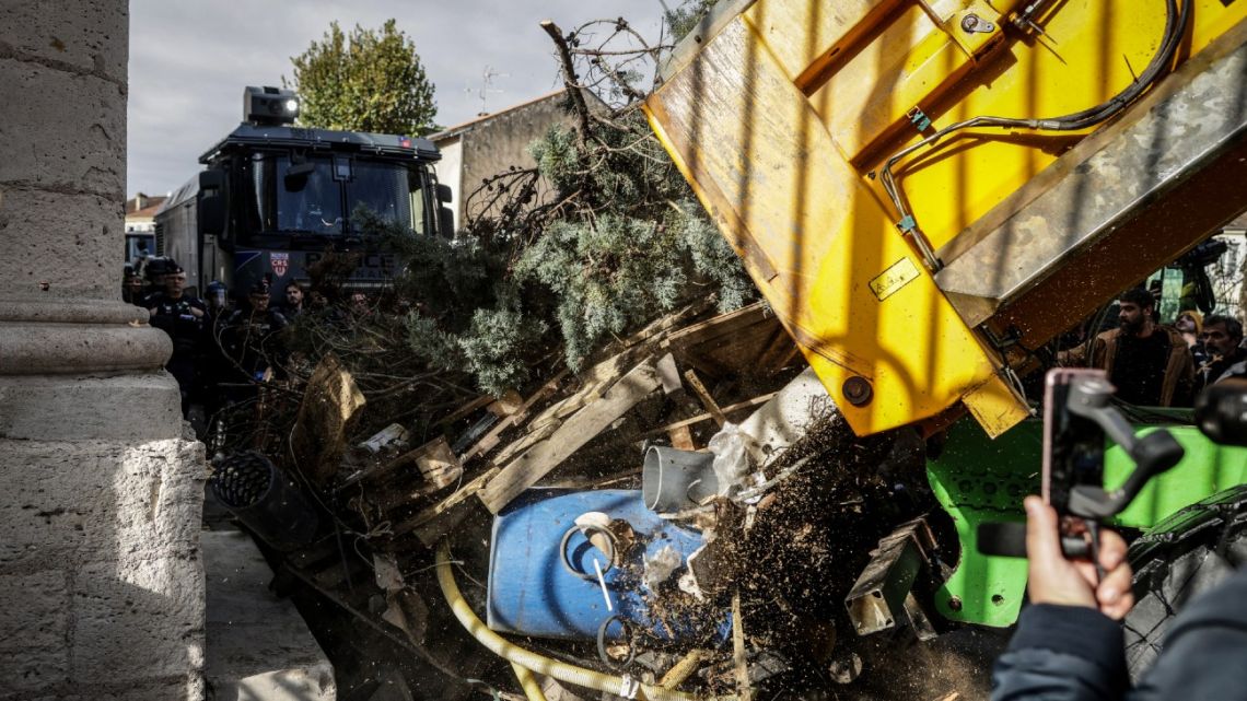 Farmers used a truck to dump used materials during a farmers protest in front of the prefecture in Agen on November 19, 2024 as part of a nationwide movement against the EU-Mercosur agreement.