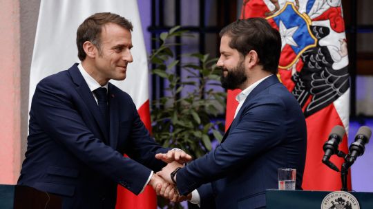 Gabriel Boric and Emmanuel Macron shake hands after a joint statement at La Moneda Presidential Palace in Santiago