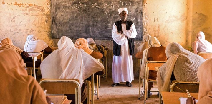 Un profesor vigila a los estudiantes de secundaria durante sus exámenes de fin de año en la aldea de Usli, en el norte de Sudán.