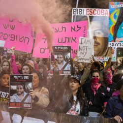 Manifestantes levantan carteles durante una protesta antigubernamental en la que exigen la liberación de los israelíes tomados como rehenes por militantes palestinos en Gaza desde los ataques de octubre de 2023, en Tel Aviv, en medio de la guerra en curso entre Israel y el grupo militante palestino Hamás. | Foto:Oren Ziv / AFP