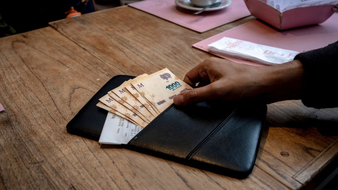 Argentine peso banknotes in a cafe in Buenos Aires, Argentina.