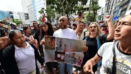 Luis Arroyo, father of two of four missing adolescents, demonstrates against their disappearance in front of the prosecutor's office in Guayaquil, Ecuador