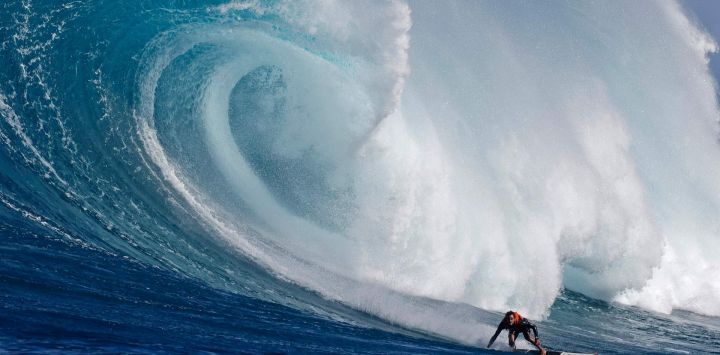 El surfista hawaiano Noah Beschen atrapa una ola en Pe'ahi Jaws Surf Break en la isla de Maui, Hawaii.