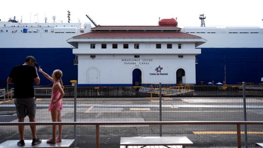 Tourists look at the Miraflores Locks of the Panama Canal in Panama City