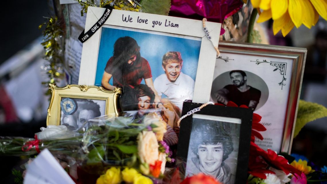 Tributes in honour of British singer Liam Payne are pictured in front of the Hotel CasaSur Palermo, where he died, in Buenos Aires on December 30, 2024. 