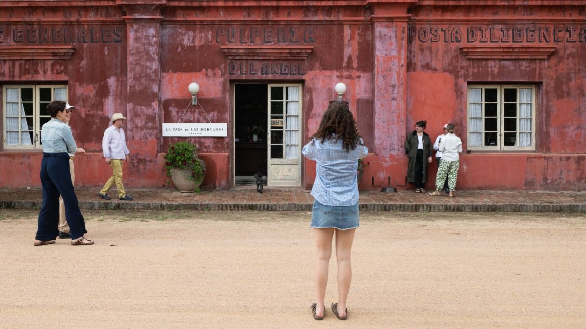 Tourists stand in front of the shop store 'La Casa de las Hermanas' during the preparations for CAMPO Artfest in Garzón, Maldonado, Uruguay on December 26, 2024. 