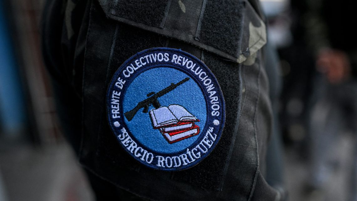 A patch that reads in spanish 'Front of Revolutionary Collectivos, Sergio Rodrïguez' is pictured on the shoulder of a member of a pro-government group known as 'Colectivos' outside his headquarters at the Perez Bonalde square in the Catia neighborhood in Caracas on January 6, 2025.