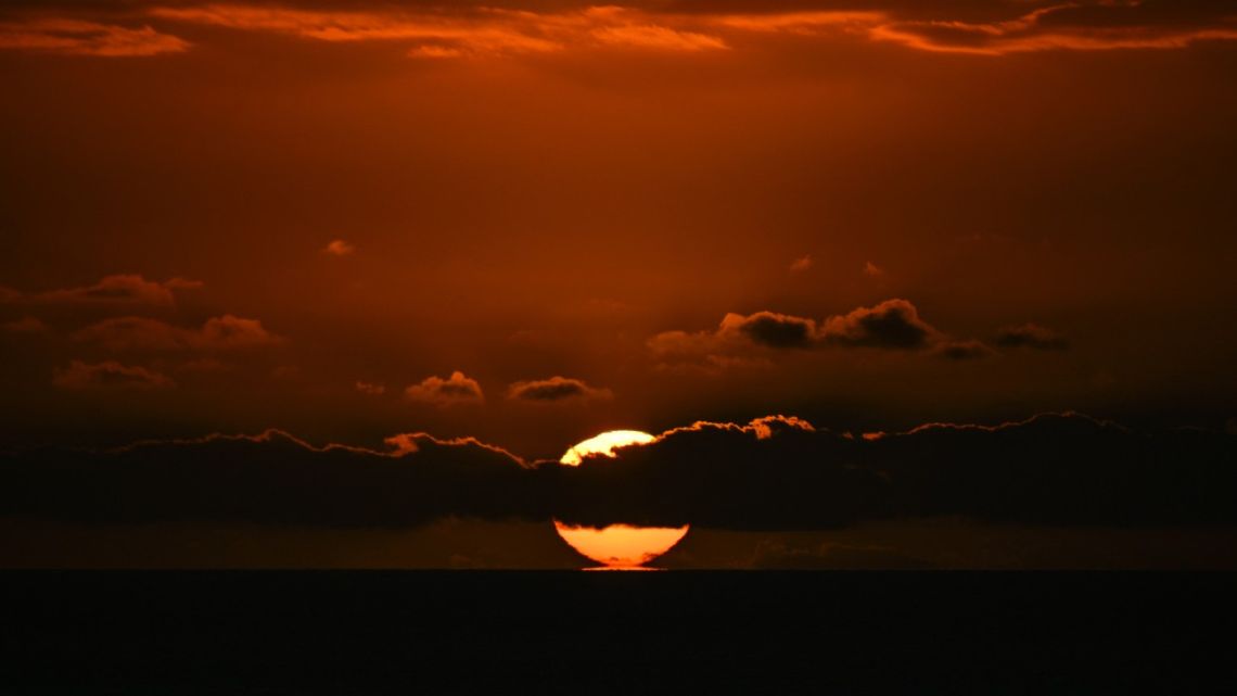 The sun rises over the Rio de la Plata estuary as seen from Montevideo on January 7, 2025. 