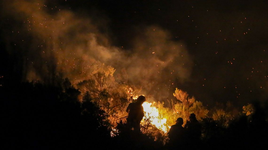 Firefighters battle a forest fire in the mountains of Epuyén, in Patagonia, Chubut Province, on January 16, 2025.  