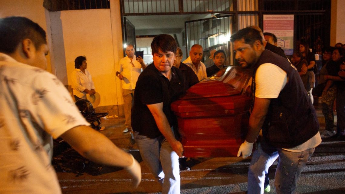 Relatives and morgue workers carry the coffin of journalist Gastón Medina outside of the morgue in Ica, Peru on January 20, 2025.