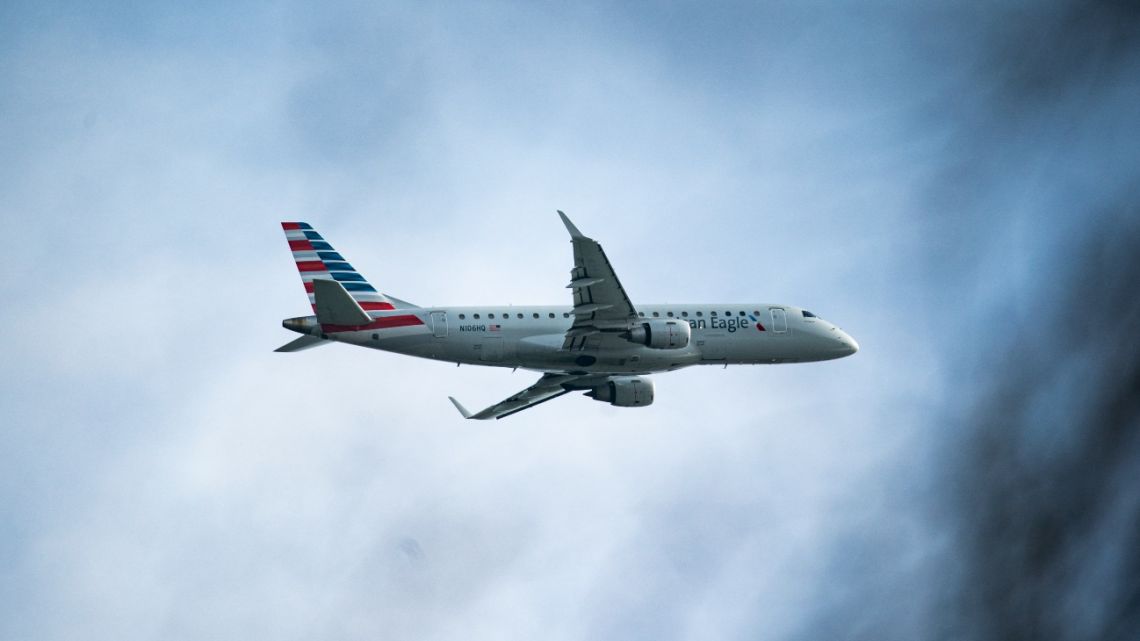 A plane takes off from Reagan National Airport after the crash of an American Airlines plane on the Potomac River as it approached the airport on January 30, 2025 in Virginia.