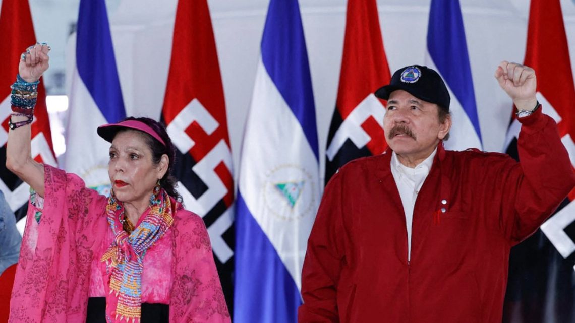 This handout picture released by the Nicaraguan Presidency shows Nicaragua's President Daniel Ortega and his wife, Vice-President Rosario Murillo, greeting supporters during an act to commemorate the 44th anniversary of the Nicaraguan Revolution in Managua, on July 19, 2023. 