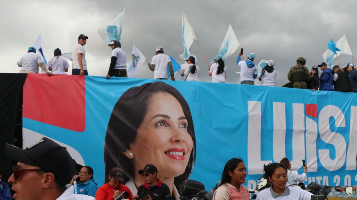 Supporters of Ecuador's presidential candidate for the Citizen Revolution Movement, Luisa González, wave flags as they take part during her final day of the electoral campaign in Quito on February 2, 2025.