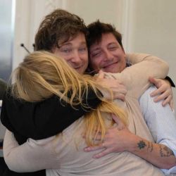 Karina Milei, Javier Milei and Santiago Caputo embrace.