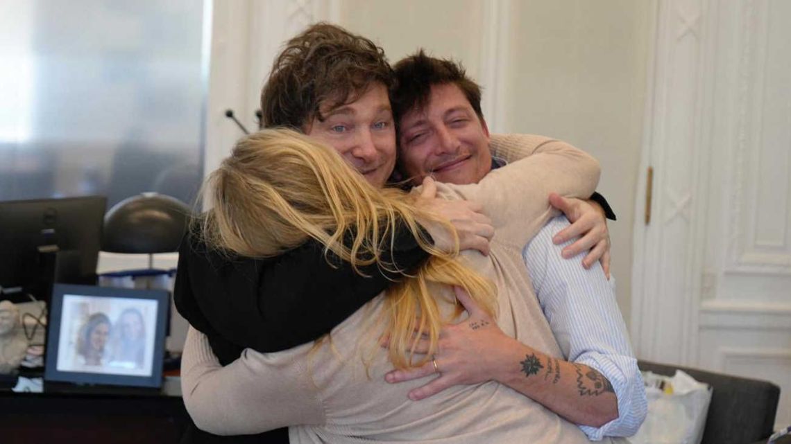 Karina Milei, Javier Milei and Santiago Caputo embrace.