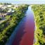 Residents concerned as waters of Greater Buenos Aires creek turn red 