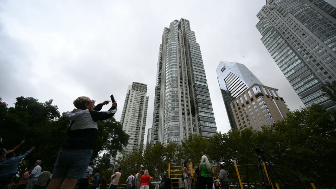 A view of the building after dozens of people were evacuated from the 51-storey apartment building that caught fire at Puerto Madero in Buenos Aires on February 11, 2025. Three people were hospitalized for smoke inhalation, 30 were assisted, and 100 were evacuated after a fire broke out Tuesday in a 50-story tower in Buenos Aires, emergency service authorities reported. 