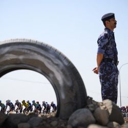 El grupo de ciclistas avanza durante la cuarta etapa de la carrera ciclista del Tour de Omán, desde el Museo Oman Across Ages hasta el Centro de Convenciones de Omán. | Foto:LOIC VENANCE / AFP