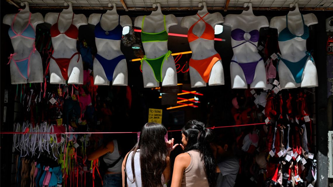 Women look at clothes in a store in Buenos Aires on February 13, 2025. 