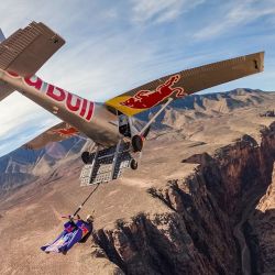 Max Manow saltó de un helicóptero, siguió a un avión en movimiento y se sujetó a él con un gancho, lo que le permitió ser remolcado con su wing suit fuera del Gran Cañón de Arizona antes de lanzarse en caída libre.