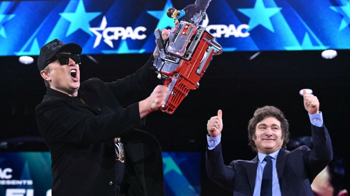 Elon Musk holds a chainsaw alongside Argentina's President Javier Milei during the annual Conservative Political Action Conference (CPAC) at the Gaylord National Resort & Convention Center at National Harbor in Oxon Hill, Maryland, on February 20, 2025. 