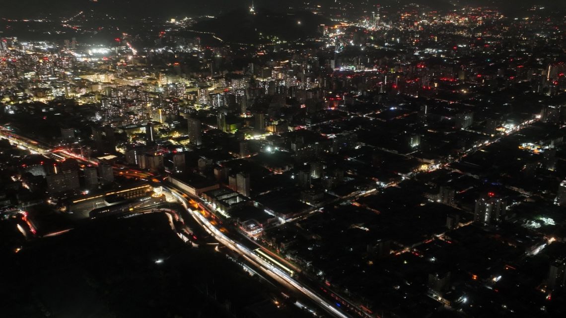 This aerial view shows the city partially illuminated during a blackout in Santiago on February 25, 2025.